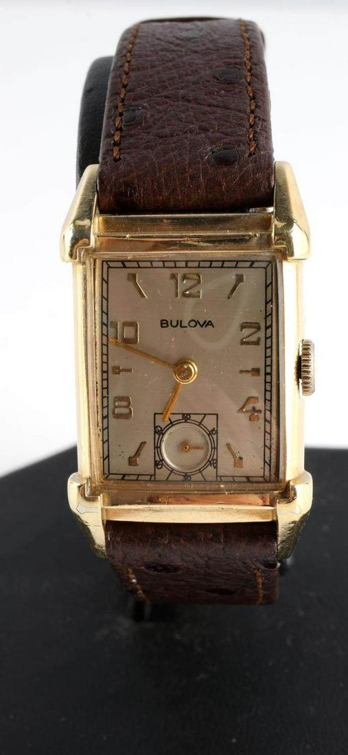 VINTAGE BULOVA STATESMAN 10 KT GOLD FILL WATCH: Bulova “Statesman”. Crystal measures 21.48 x 17.90mm. Case measures 28.58 x 22.33mm. Manual movement serviced 2019. High quality 21 jewel Bulova 7Ak movement. 10K gold filled. Tank style case. Goo
