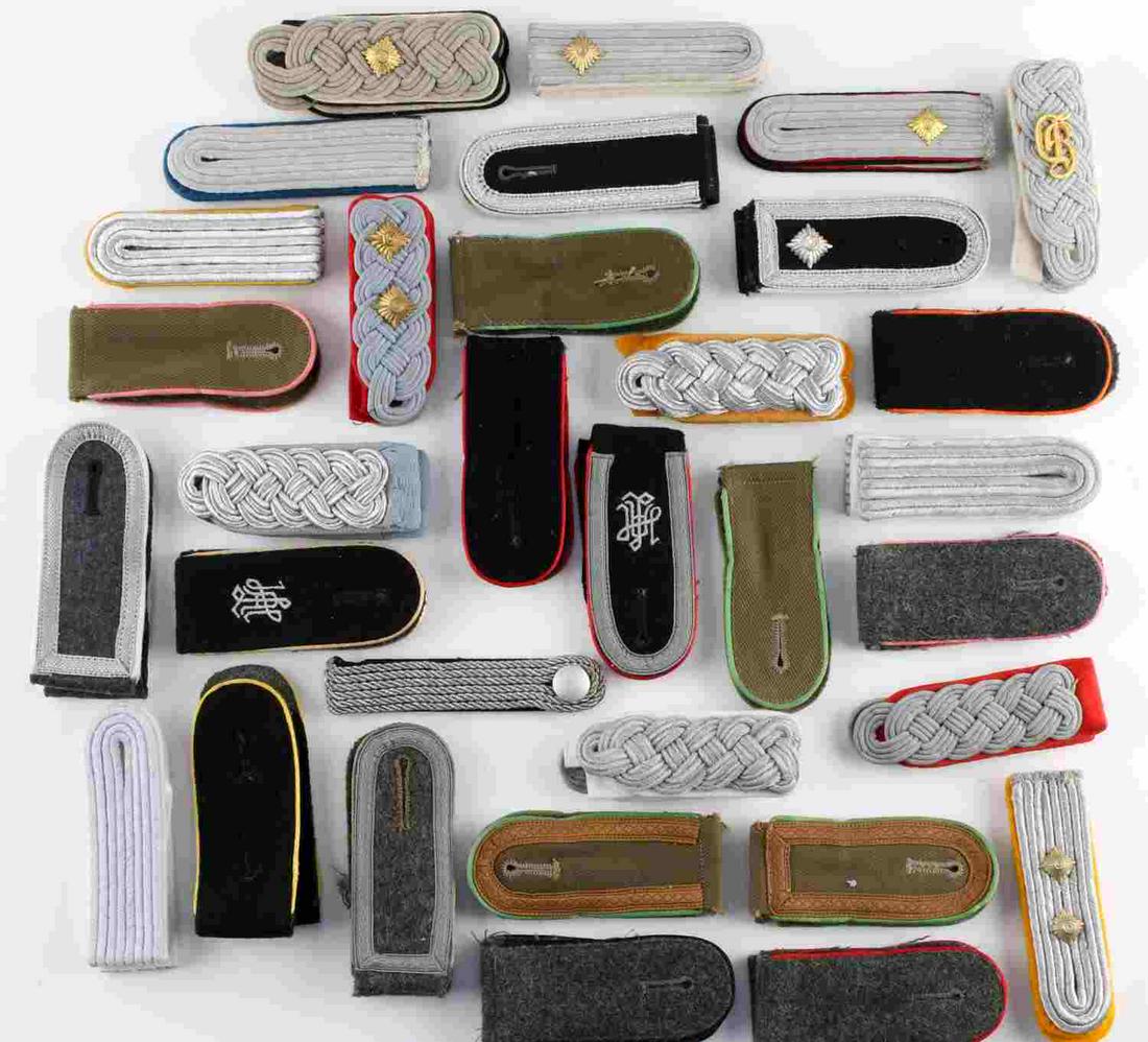 LOT OF 32 WWII GERMAN THIRD REICH SHOULDER BOARDS: Variety lot of Third Reich shoulder boards for artillery, infantry, military police, and armor with varying degrees of rank. Some fluoresce but most do not. Good condition. Measure 4 1/4 inches.