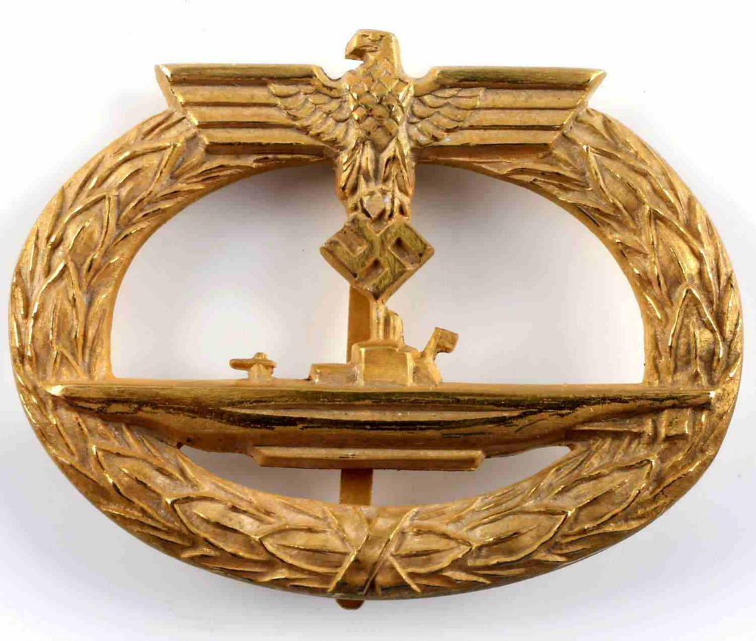 WWII GERMAN UNISSUED KRIEGSMARINE U BOAT BADGE: Gold tone, good detail, stout vertical pin with C-hook closure. No markings. Still in tissue. Very good condition. This lot has a reserve.