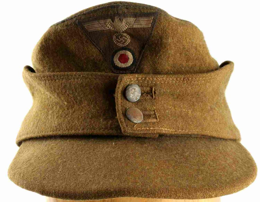 WWII GERMAN THIRD REICH AFRIKA KORPS M43 HAT: WWII German Afrika Corps M43 Cap. Tan with tan interior cloth lining. Parteiadler eagle and Nazi party insignia on the front are stitched in and faded with age. Does not fluoresce. Zero mothing presen
