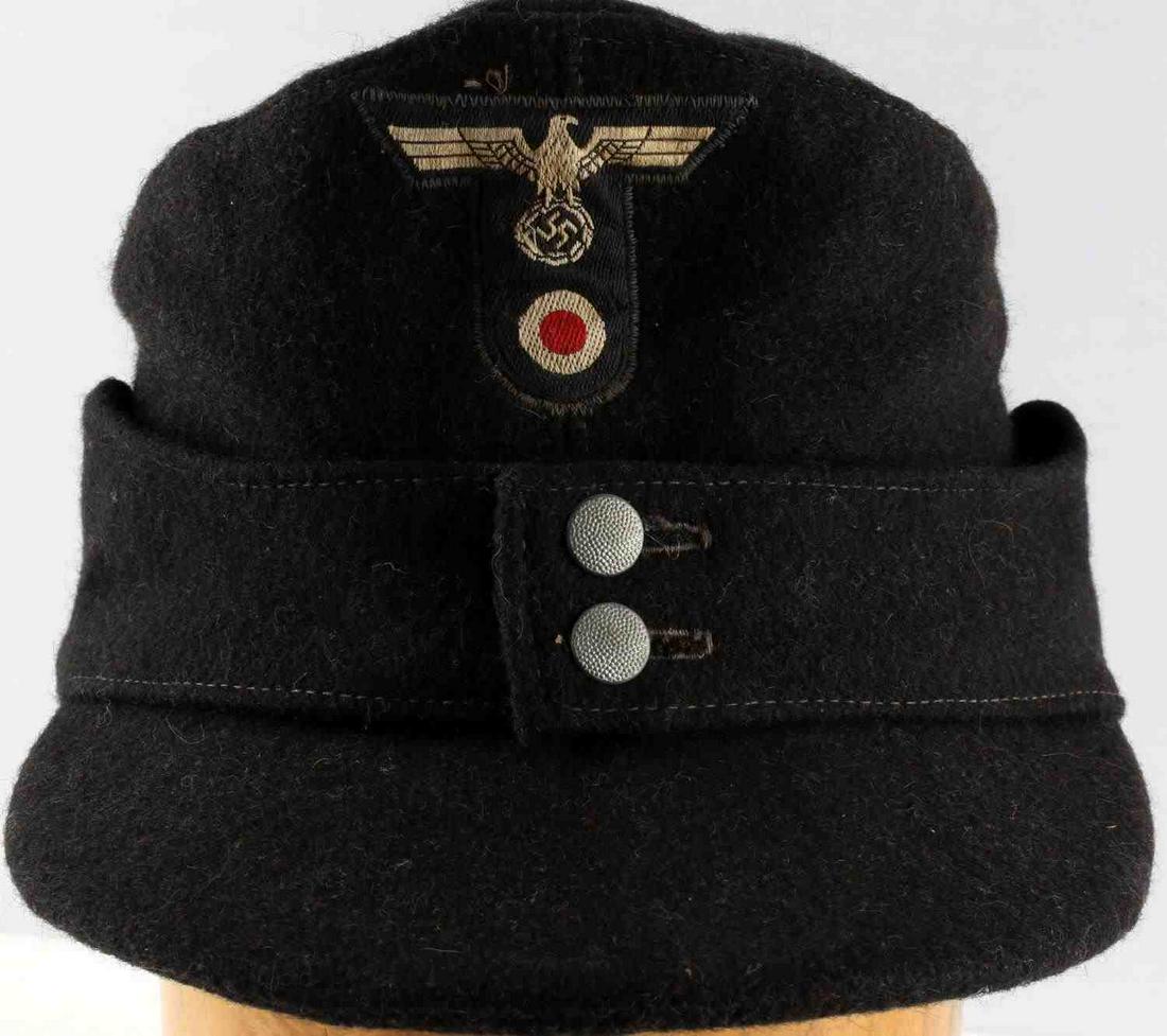 WWII GERMAN THIRD REICH PANZER M43 FIELD CAP: Third Reich Panzer M-43 field cap. Features Parteiadler with cockade patch and pebbled buttons. Constructed of black wool. Interior reads "R Btr Nr 0/0265/504" Parteiadler and cockade on front fluores