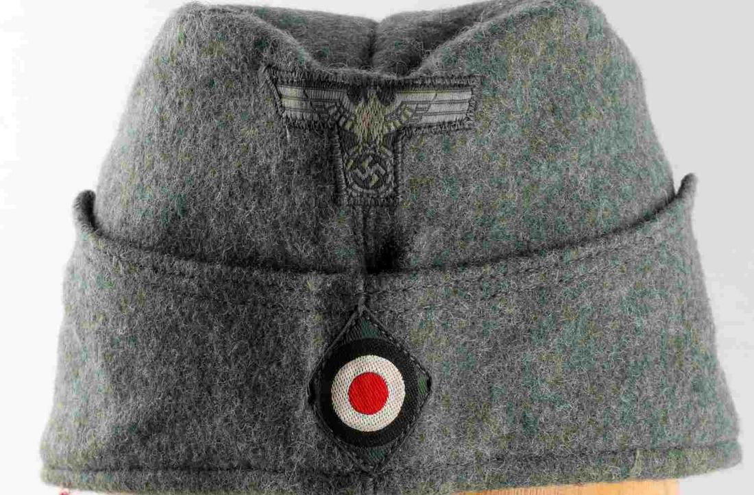 WWII GERMAN THIRD REICH SS OFFICER SIDE CAP HAT: Third Reich SS Side cap. Features Parteiadler with cockade. Measures 11 inches. Size 58. Clemens Wagner marked. Non-fluorescing. Good condition.