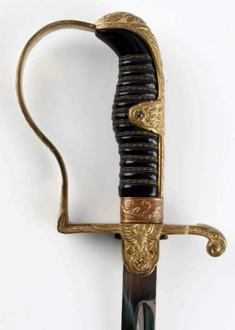 WWII GERMAN THIRD REICH ENGRAVED HOLLER SWORD: Engraved chrome blade "Praise That Which Makes Hard", Holler maker. Monogrammed crossguard, scratched to scabbard but dent free, wire wrapped Bakelite grip with D-guard. Very good original condition.
