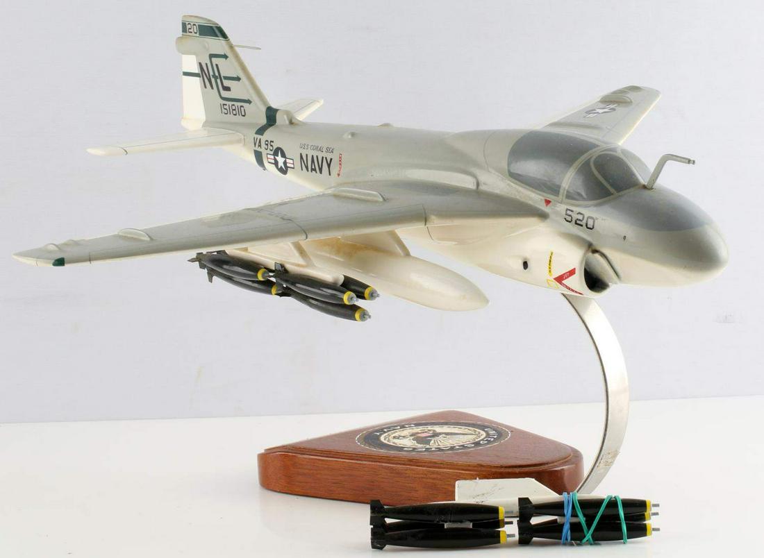 GRUMMAN US NAVY TWINJET A6 INTRUDER MODEL DISPLAY: Grumman US Navy twinjet A6 "Intruder" model display attack aircraft with stand. Plane model measures approximately 16 1/4 inches long with a wingspan of 16 1/16 inches and sitting at 10 inches tall. P