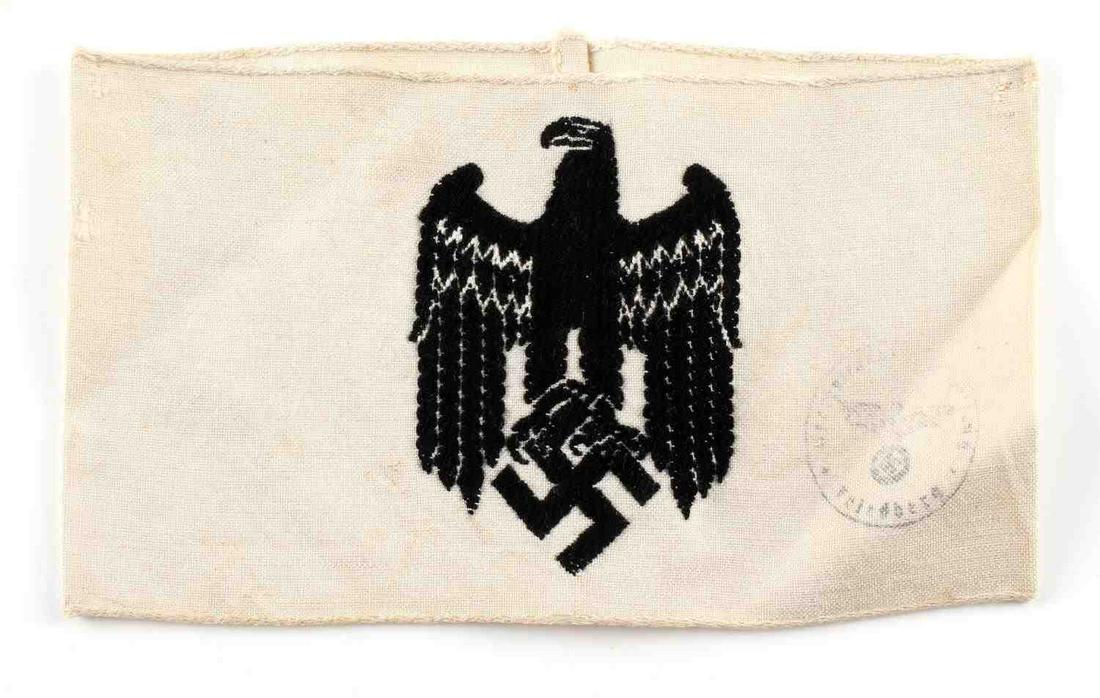 WWII GERMAN REICH PARADE STEWARD ARMBAND: WWII German Reich parade steward armband measuring 6 5/8 inches wide by 3 13/16 inches tall. ReichsKanzlerei eagle design stitched onto front, along with stamp on right side. In good condition, does n