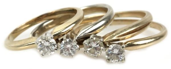 DEALERS LOT 4 14K GOLD DIAMOND SOLITAIRE RINGS: 3 yellow gold rings and 1 white gold ring. Each ring has a diamond solitaire of approximately 1/4 ct. Averaging SI-1 clarity and H-J color. . Size: 4.75-9 . Weight: 7.77g . Condition: Very good