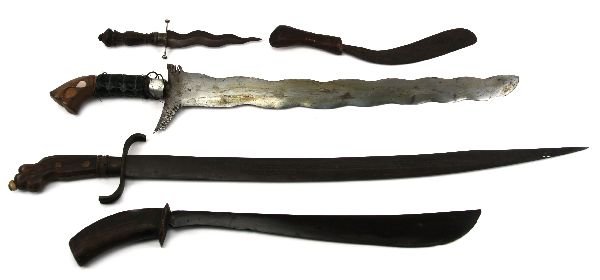 MIXED LOT OF PACIFIC ISLAND AND SE ASIAN KNIVES: Grouping of five knives and swords. A Filipino Garab knife, with handcrafted bamboo sheath. Knife is dark from rust stain, but very sharp. Measures 22" overall. A non specific type sword, with a cutla