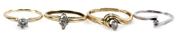 DEALER LOT OF 4 GOLD DIAMOND SOLITAIRE RINGS: To include: a size 5.5 14k yellow gold ring with a .350 ct round cut diamond, a size 6 10k white gold ring with a .0625 ct diamond, a size 6. 14k yellow gold ring with a marquise cut .4 ct diamond, an