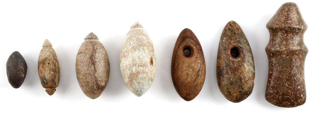 7 NATIVE AMERICAN PLUMMET STONE AXE ARTIFACTS: Lot of 7 includes Florida stone plummets, bannerstones, and a small stone axe form. Measurements range 1 1/2 - 4 1/4 inches. Good condition.