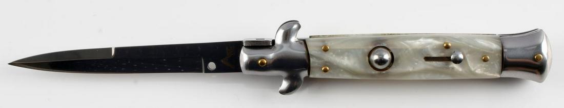 9 INCH AKC ITALIAN MADE SWITCHBLADE KINFE: AKC Italian made switchblade knife. 9 inches open. Stainless steel knife. Pearl-like grip. Very good condition.