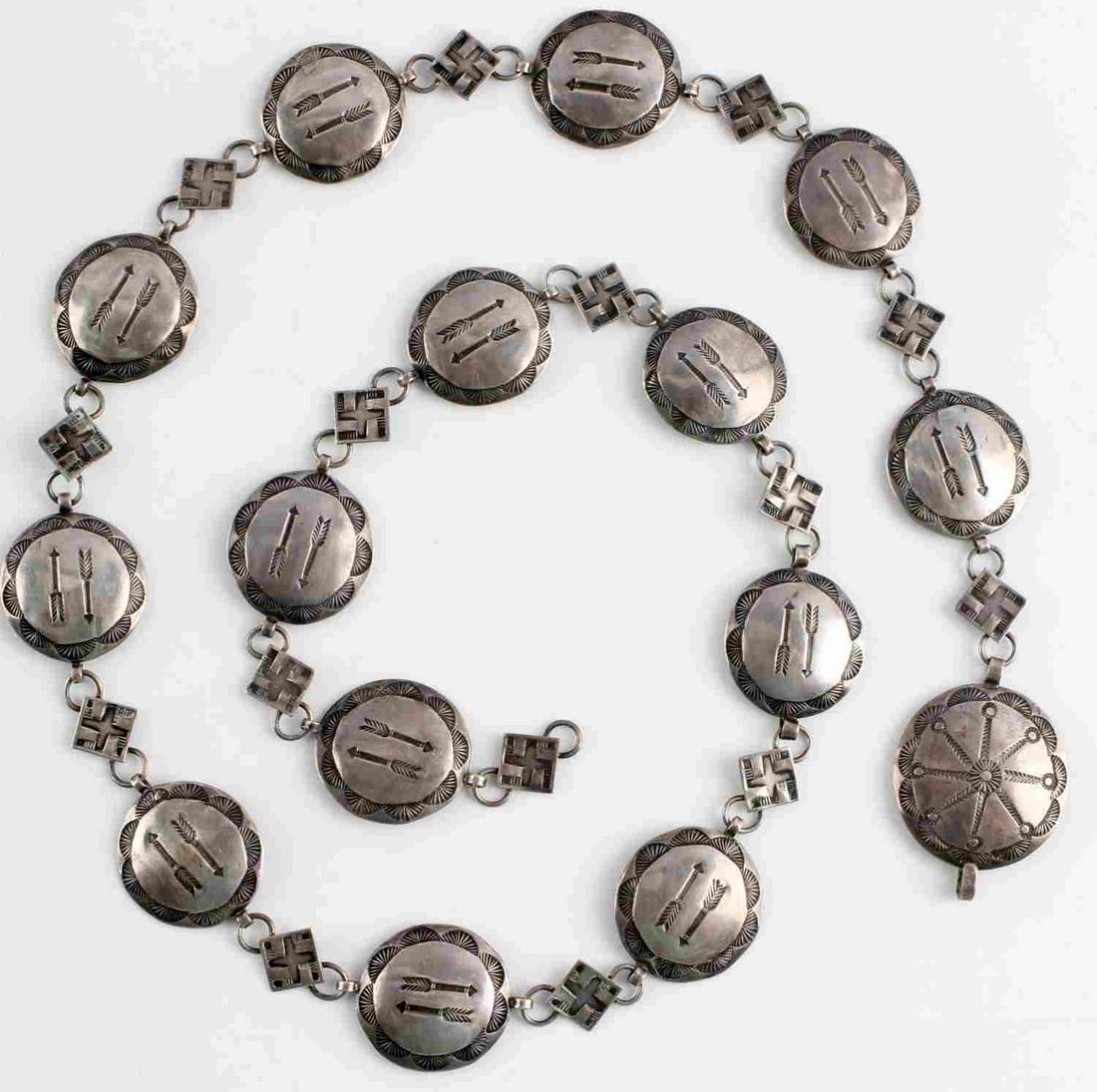 OLD PAWN NATIVE AMERICAN STERLING CONCHA BELT: 31 inch sterling silver concha belt with 1 1//8 inch stamped warrior arrows circular conchos and whirling log swastika connecting small 1/2 inch diamond shaped conchos. Unmarked, acid tested as sterli