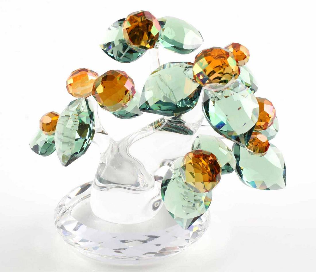 SWAROVSKI CRYSTAL ASIAN ICON KUMQUAT TREE FIGURINE: Depicts huge kumquat fruits with green leaves on clear base. Measures 5.5 inches tall and 5.5 inches wide. Very good condition.