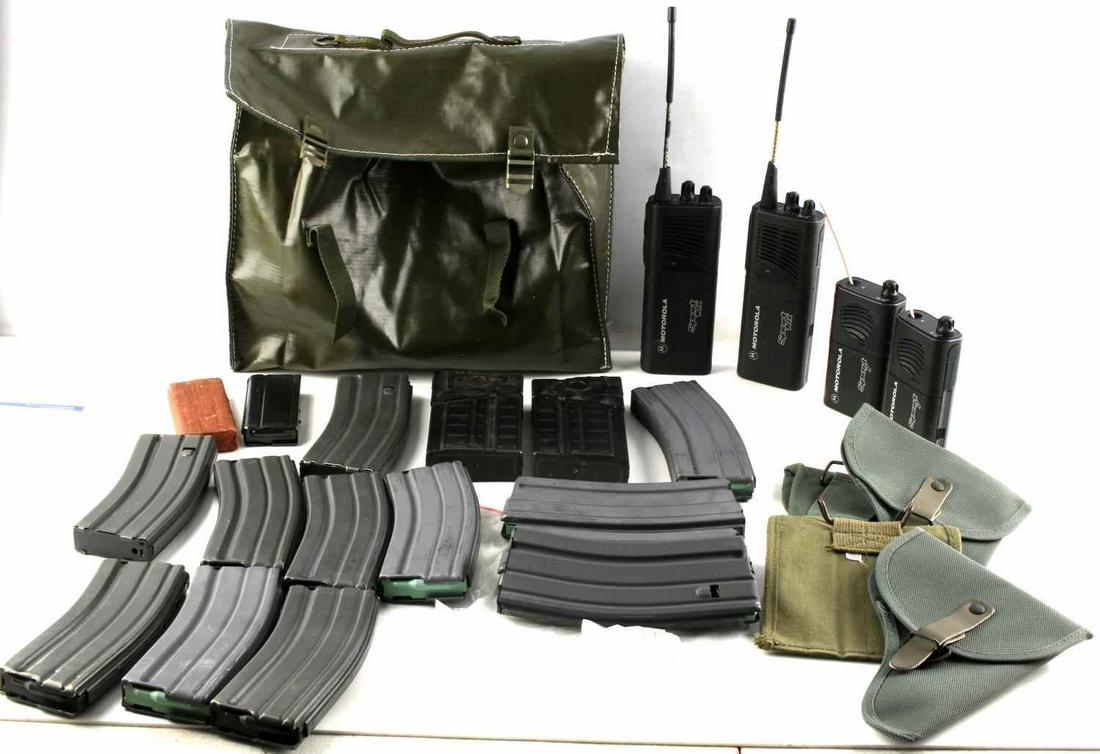 25 COLT AR 45 COLT MAGAZINE WALKIE TALKIE HOLSTER: Lot includes several Colt AR-15 magazines, 2 G3 magazines, 2 .45 Colt magazines, 4 Motorola walkie talkies, a medium green bag, and several holsters. Good condition. Measurements range 4 - 9 inches.