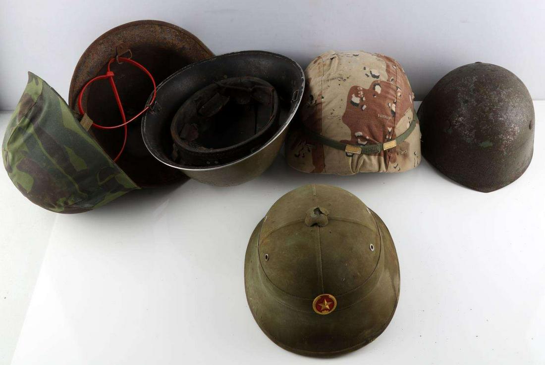 WWI WWI VIETNAM DESERT STORM MILITARY HELMET LOT: Includes combat relic Viet Cong helmet, WWII Italian helmet with liner no chinstrap, rough outer finish, French M-1 helmet, WWI Brodie and Eastern Bloc helmet