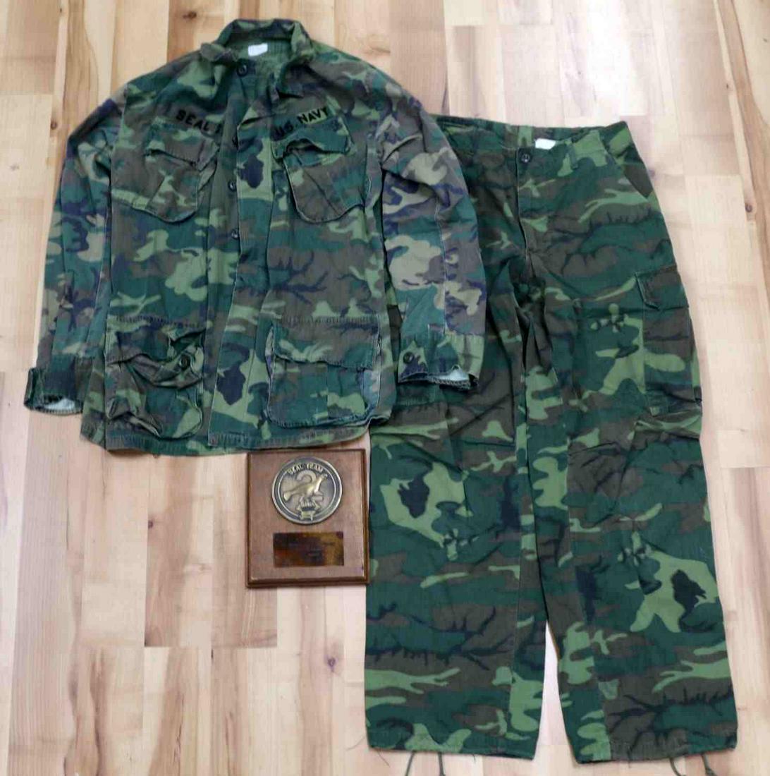 US SEAL TEAM 2 RUDY BOESCH PLAQUE WITH UNIFORM: U.S. military Navy Seal Team 2 plaque to Rudy Boesch. Plaque features a seal with SEAL TEAM 2 with a parachute and gun. Bottom reads "In Recognition For Services Above and Beyond Seal Extraordinaire R