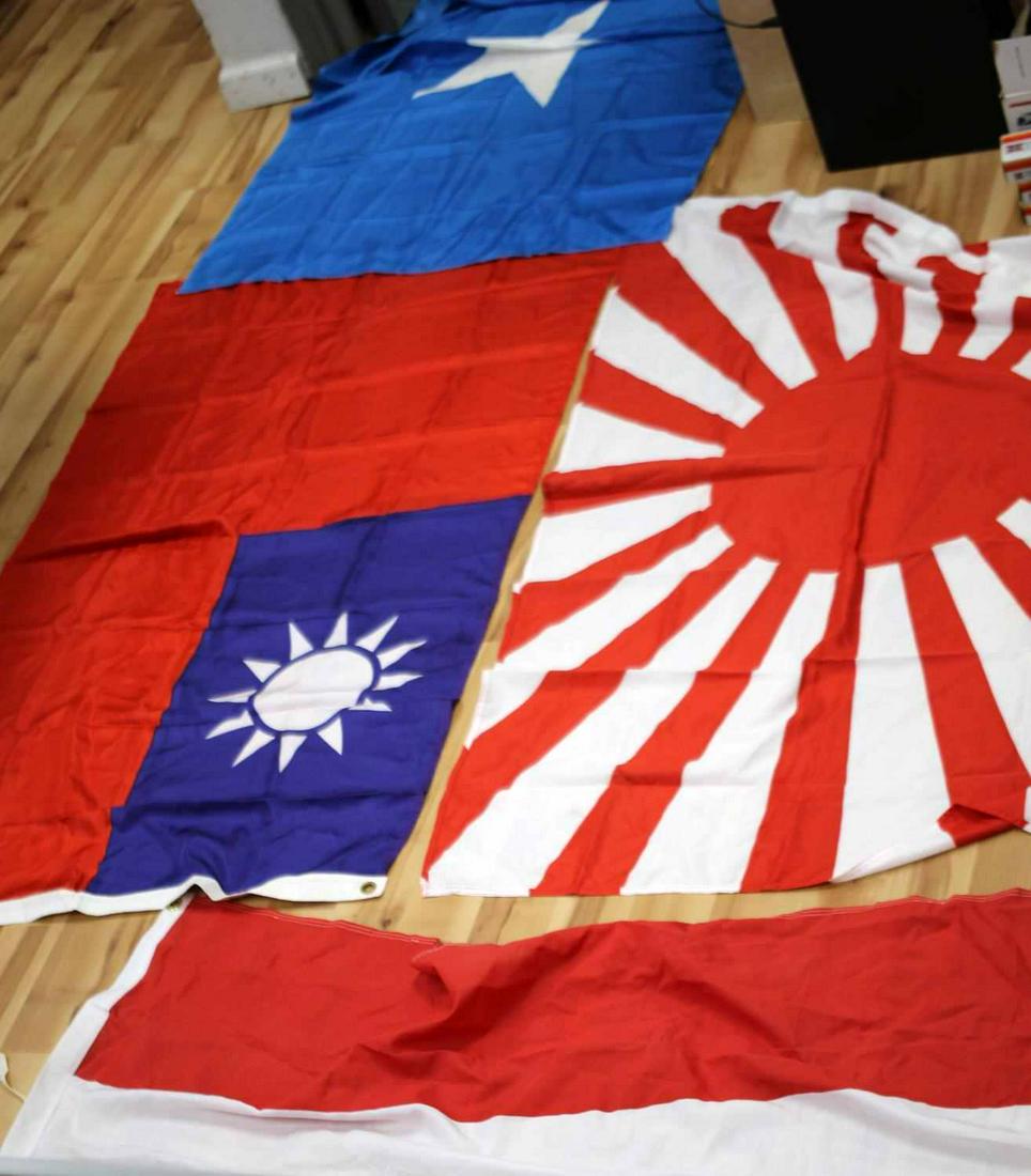 LOT OF FIVE FLAGS TAIWAN TEXAS AND JAPANESE: Lot includes a Republic of Texas Bonnie Blue flag, a Flag of Taiwan, a Flag of Japan, a flag of Austria, and a small blue flag. Good condition. Measure approximately 55x34