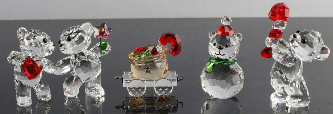 SWAROVSKI CRYSTAL CHRISTMAS FIGURINES LOT OF 4: Includes: double bear, bear with candy cane, bear snowman, and sled with present and candy cane. All pieces measure under 2.5 inches tall. Hallmarked at bottom. Very good condition.