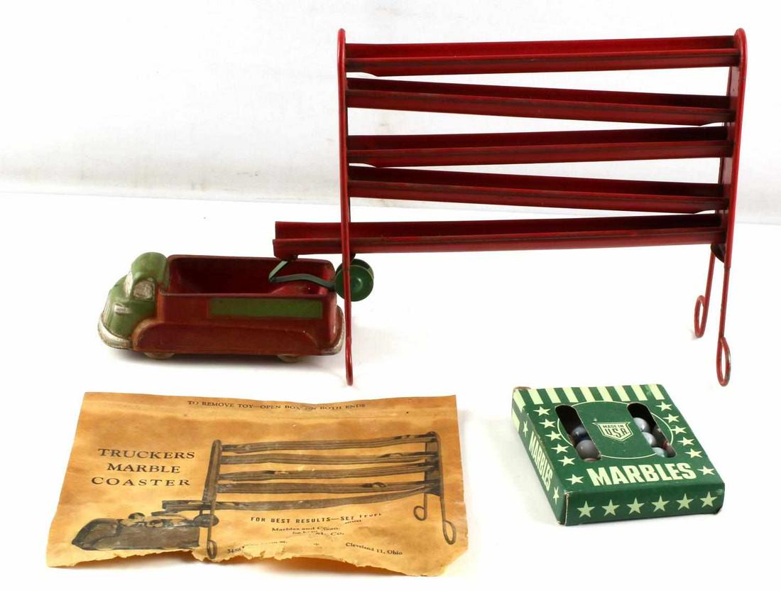 DIE CAST MARBLE COASTER W ARCOR SAFE PLAY TOY CAR: Die cast metal marble coaster, painted red, 8.75 X 8 inches, with hard rubber Arcor toy car (5.75 inches), and 28 marbles. Good vintage condition.