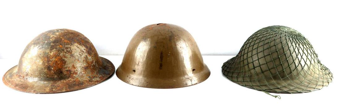 LOT OF 3 WWII BELGIAN BRITISH JAPANESE HELMETS: Lot features a Belgian brodie, a British brodie, and a japanese helmet. Good condition. All feature some oxidation. Japanese helmet has a hole and cracking at the top with a crude weld.