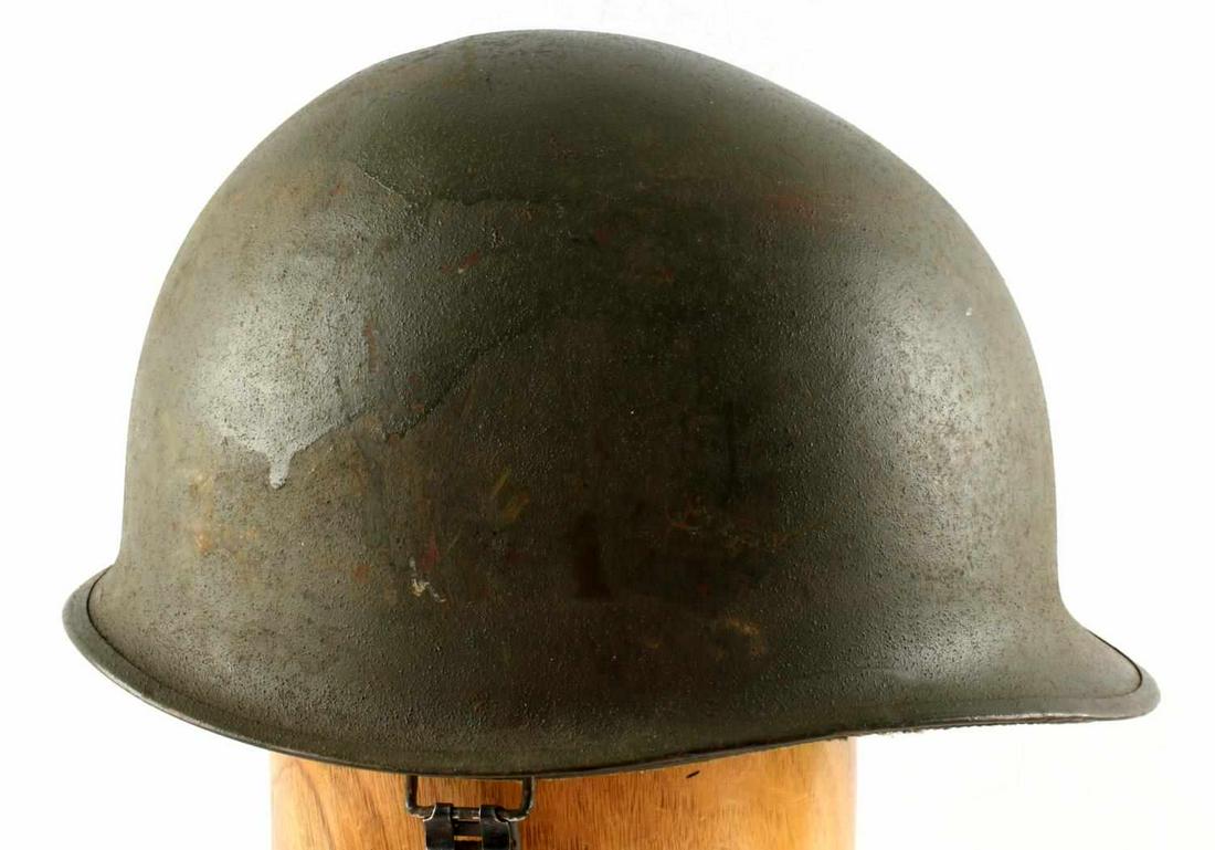 WWII U.S. MILITARY M1 COMBAT HELMET WITH LINER: Green steel helmet with canvas and leather liner. No markings. Good condition. Measures 11 X 9 inches across front to back inside. Rusting and paint loss to helmet.