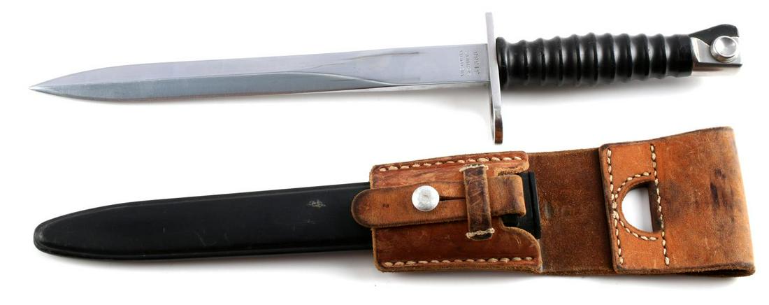 M1957 SWISS STURMGEWEHR RIFLE BAYONET & FROG: M1957 Sturmgewehr 57 bayonet, scabbard & leather frog. Blade measures 9 3/8 inches long, and is marked "Victoria Schwyz" & "31388" on one side of the ricasso and has a maker's mark on the other side. 