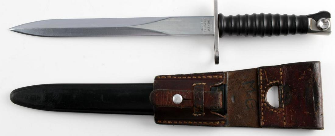 M1957 SWISS STURMGEWEHR 57 BAYONET W FROG: M1957 Sturmgewehr 57 bayonet, scabbard & leather frog. Blade measures 9 3/8 inches long, and is marked "Victoria Schwyz" & "23400" on one side of the ricasso and has a maker's mark on the other side. 