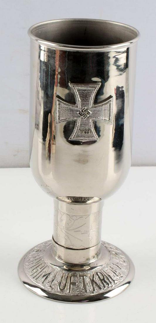 WWII GERMAN LUFTWAFFE HONOR GOBLET MODERN: Chrome plated brass goblet with Iron Cross to one side, eagle atop other eagle to other side, and 'fur besondere Leistungen im Luftkrieg' in relief at bottom rim. Stands 10 inches tall. Unauthenticate