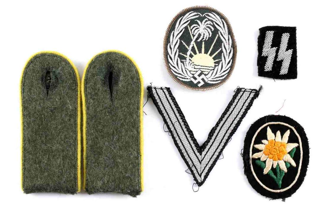 6 WWII GERMAN THIRD REICH SS AFRIKA KORP PATCHES: Lot includes a pair of shoulder boards, an edelweiss patch, an Afrika Korps patch, an SS patch, and a V patch. Good condition. All fluoresce. Measurements range 1 5/8 - 4 1/4 inches. Unauthenticated, 