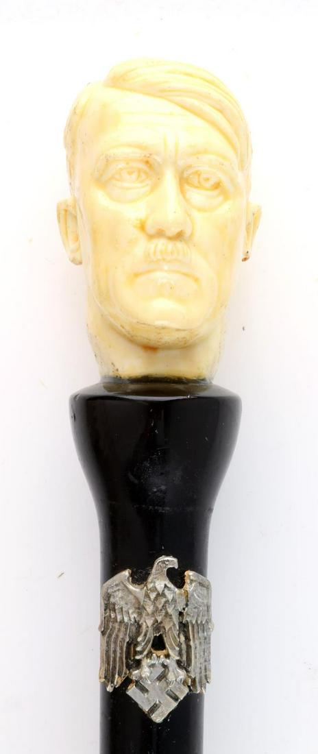 FANTASY WWII GERMAN THIRD REICH HITLER SWORD CANE: Fantasy sword cane. Features a bust of Adolf Hitler atop a black cane. Blade is made of stainless steel and made in Taiwan. Cane measures 37 1/2. Blade measures 16 1/2 inches.