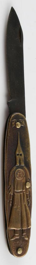 VINTAGE KKK KU KLUX KLAN POCKET KNIFE: Vintage Ku Klux Klan pocket knife. Klansman to the one side with the bible above and gravel below. Opposite side reads "KU KLUX KLAN" with cross to left and bible to right. Dark blade does rotate and