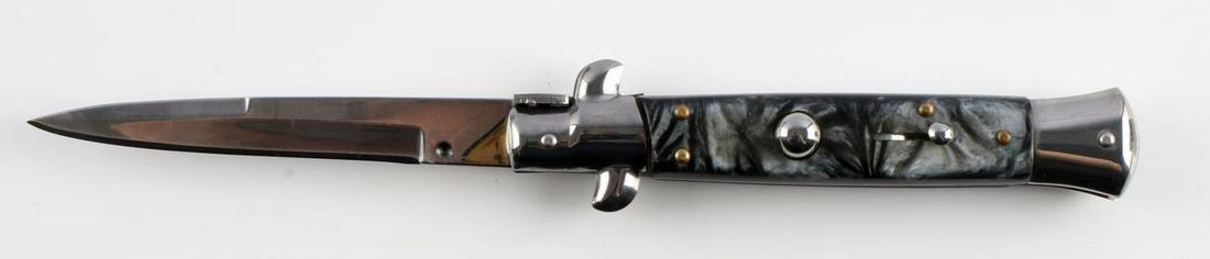 8 3/4 INCH STILETTO LIKE SWITCHBLADE KNIFE: Stiletto-like switchblade. 8 3/4 inches open. Stainless steel blade made in China. Black pearl-like grip. Very good condition.