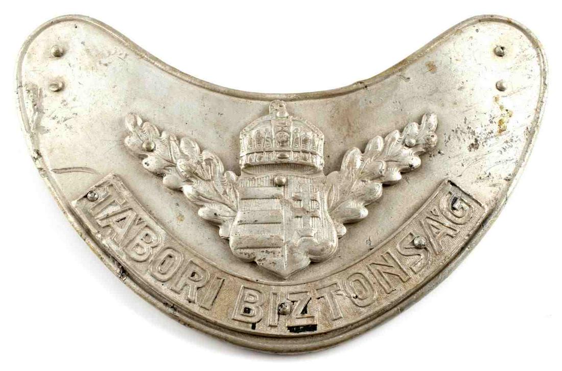 WWII HUNGARIAN MILITARY POLICE GORGET NO CHAIN: Hungarian military police gorget. Features crest with oak leaves and "Tabori Biztonsag." Aluminum construction with 9119 on reverse. Measures 6 1/4 inches. Good condition. Unauthenticated, sold as is.