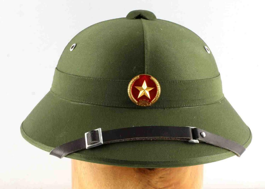 POST WAR VIETNAMESE ARMY PITH HELMET: Vietnamese Army pith sun helmet, post-Vietnam War; has liner and chinstrap with maker's label. Liner outline is detached. Measures 7.5 inches front to back inside. Very good condition.