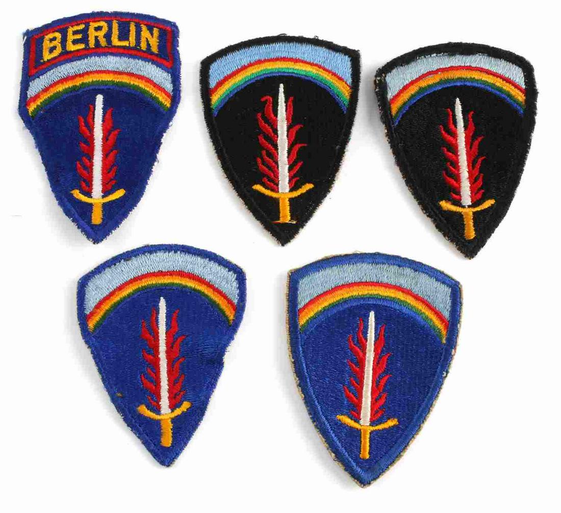 US MILITARY ARMY PATCH LOT OF 5 W BERLIN COMMAND: 5 patches, blue and black, with flaming sword and rainbow at top, plus one Berlin Command patch. Good condition. Unauthenticated, sold as is.