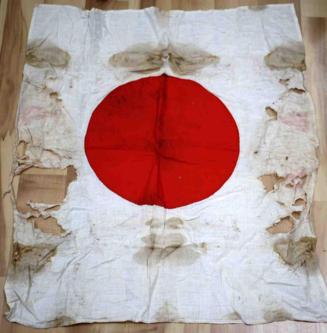 WWII JAPANESE IMPERIAL ARMY BATTLE MEATBALL FLAG: WWII Imperial Japanese meatball battle flag. In battle condition. Features staining, rips, and fading but the red symbols holds true to its bright color. Measures 28 x 23 inches.