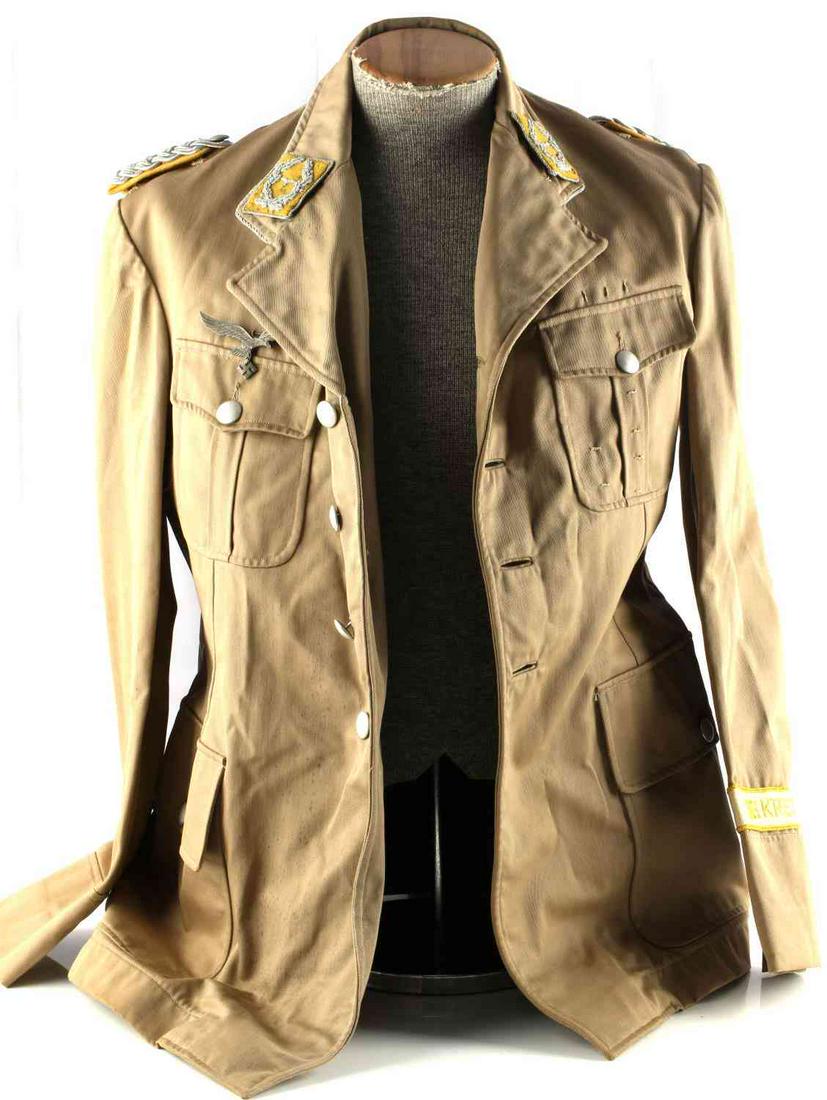WWII GERMAN REICH AFRIKA KORPS LUFTWAFFE TUNIC: Third Reich Afrika Korps Luftwaffe tunic. Features officer shoulder boards, Luftwaffe collar tab, breast eagle, and pebbled buttons. Good condition. Minor fluorescing. Large sized. Unauthenticated, so