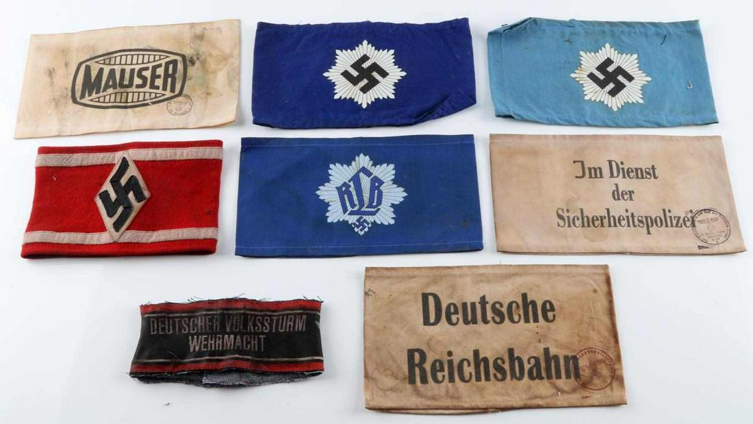LOT OF 6 WWII GERMAN THIRD REICH ARMBANDS: Lot features RLB, National Air Defense, automotive, people's militia armbands. Measurements range 6-8 inches. Good condition. Hitler Jugend and Mauser armbands fluoresce. Unauthenticated, sold as is.