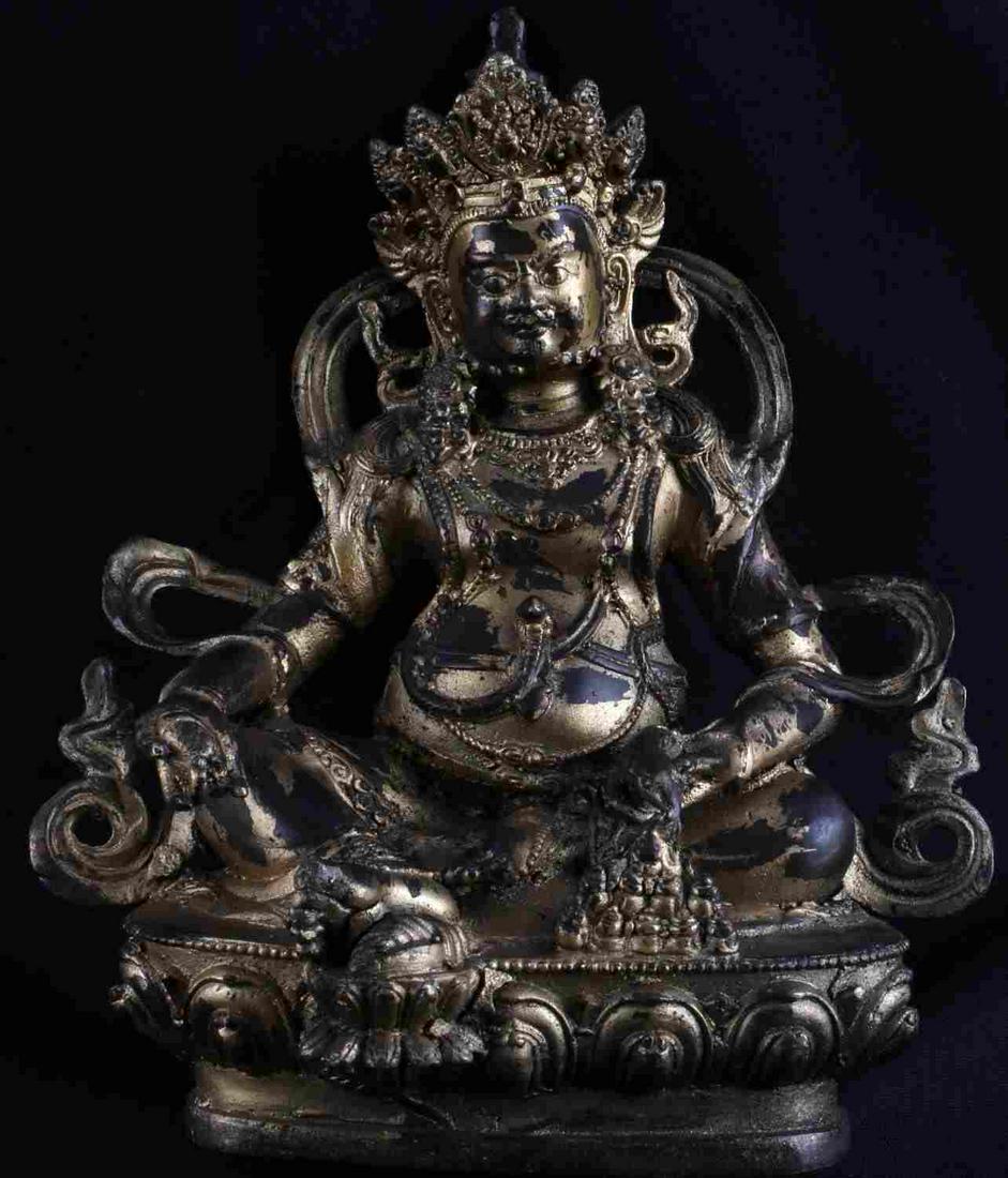 BRONZE STATUETTE OF BUDDHIST WEALTH DEITY JAMBHALA: Gilt bronze statuette of Jambahala, a Buddhist Bodhisattva, guardian of light in Buddhism, a great charitable deity who grants fortune, material wealth, spiritual wealth, protection and especially fin