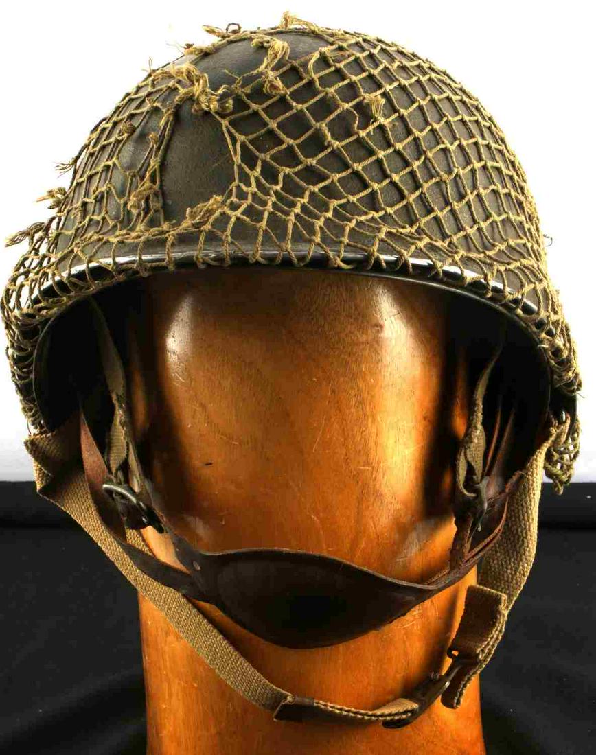 WWII US MILITARY M2 PARATROOPER HELMET FIXED BALE: 1942 Period WWII US M2 fixed bale, front seam parachutist helmet with tortoise shell liner. Exterior OD#3 olive camo includes straps and netting, nets are torn in a few segments. Interior liner marked