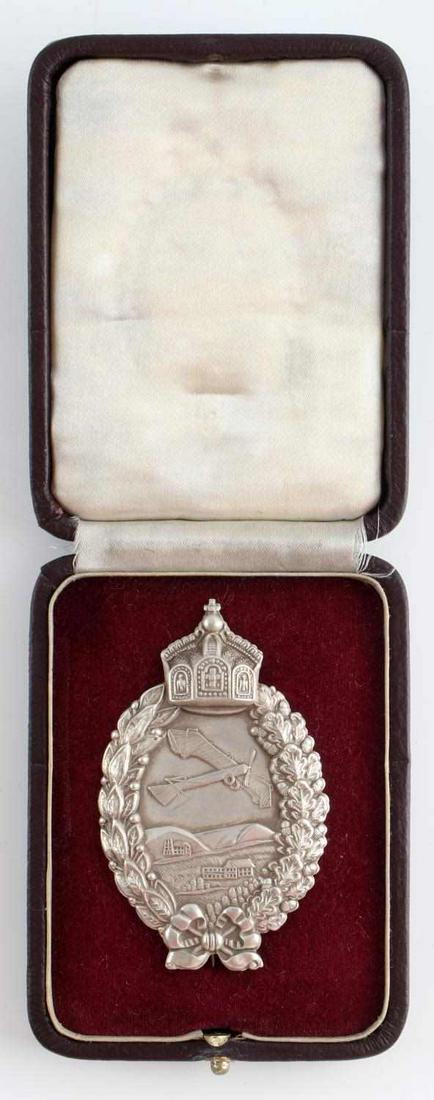 WWI PRUSSIAN PILOT BADGE IN 800 SILVER WITH CASE: WWI Prussian pilot's badge. Stamped construction. Pin marked 800. Comes with case. Badge measures 2 3/4 inches. This lot has a reserve.