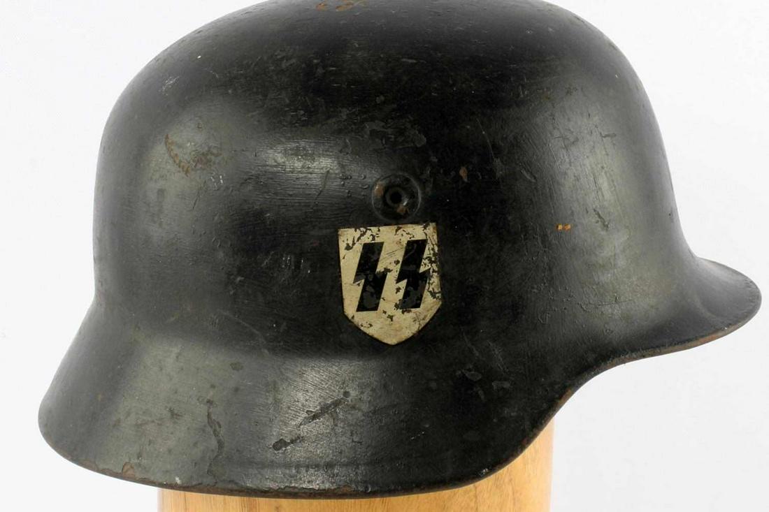 WWII GERMAN THIRD REICH DOUBLE DECAL SS HELMET: WWII German Third Reich double decal Waffen SS M40 helmet. SS decal on right side, National decal on left side. Single vent on either side, no rivets. Metal head band, unmarked. no liner, 64 marked on