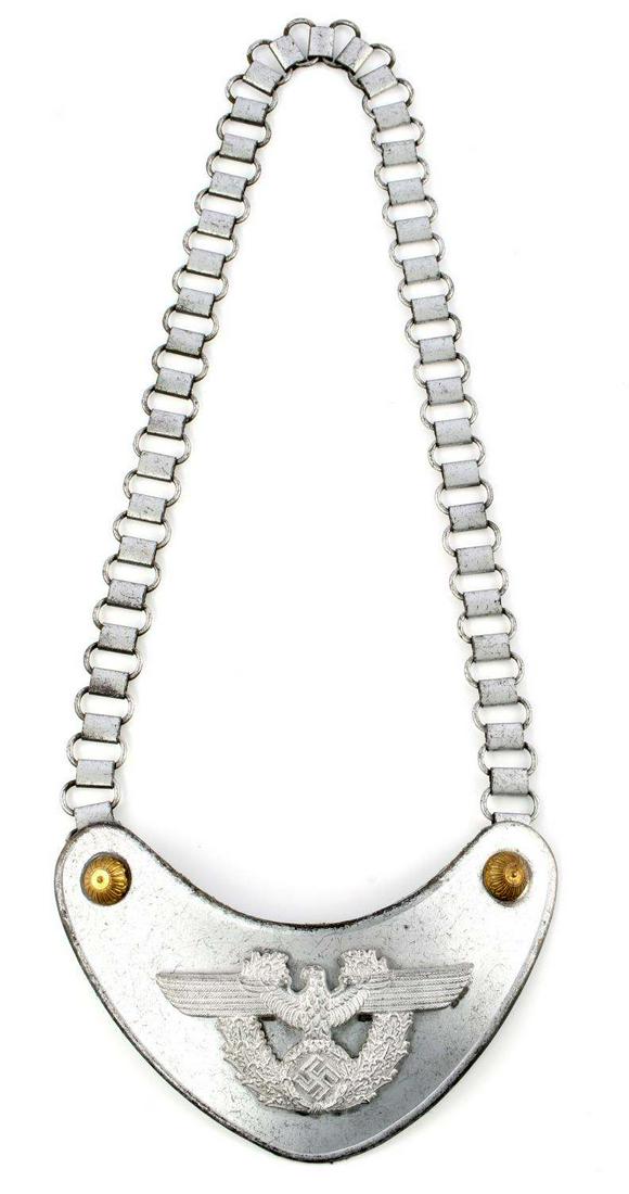 WWII GERMAN THIRD REICH POLICE GORGET: WWII German Police gorget. Obverse features Polizei eagle. Maker marked 'A' for Assman to reverse. Green wool backing, chain, and uniform hooks. 6 1/2 X 4 1/2 inches. Does not fluoresce. Good conditio