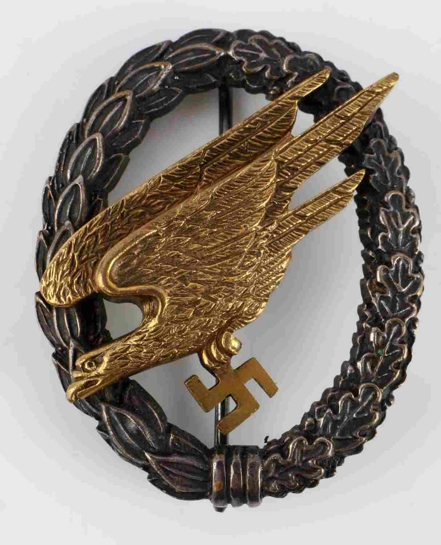 WWII GERMAN REICH LUFTWAFFE PARATROOPER BADGE: WWII German Third Reich Luftwaffe paratrooper badge. Oak and laurel leaf wreath with riveted diving eagle clutching swastika. Black and gold finish. JMME C. Sohn Berlin marked to reverse. Measures 2 1