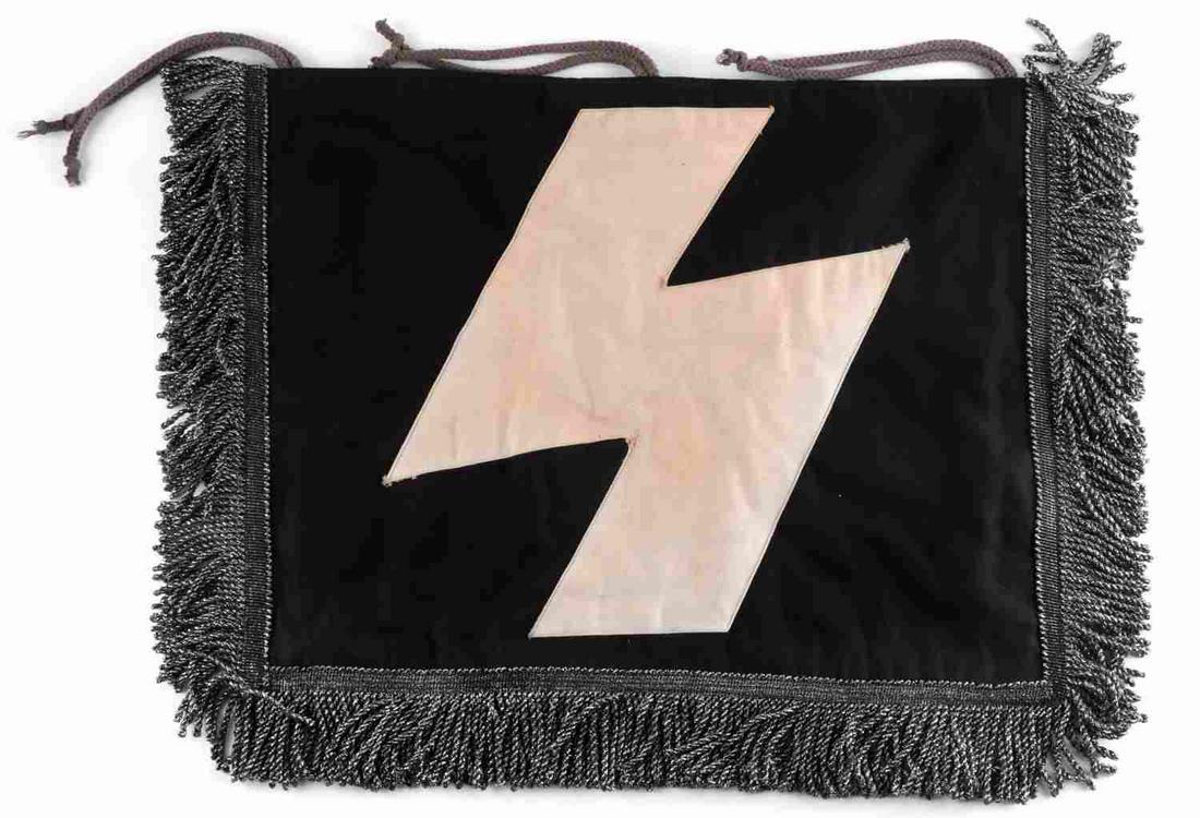 WWII GERMAN THIRD REICH SS TRUMPET BANNER FLAG: Third Reich SS trumpet banner flag. Features a white Sig Rune sewn atop of a black banner with bullion curl fringe. Measures 14 x 18 inches. Bullion fluoresces. Good condition.