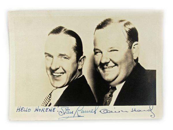1944 AUTOGRAPHED PICTURE OF LAUREL AND HARDY: Unusual photo of Stan Laurel and Oliver Hardy from 1944. Neither is wearing or holding a hat. Hand signed "Hello Norene" followed by signatures. Back of photo is hand dated Jan 12, 1944 and is accompa