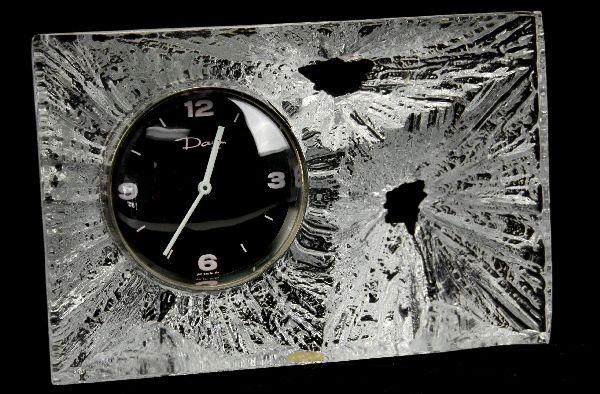 DAUM FRANCE CRYSTAL DESK CLOCK: A heavy crystal clock signed "Daum France". Swiss made AA battery operated clock with black dial and silver trim ring.
