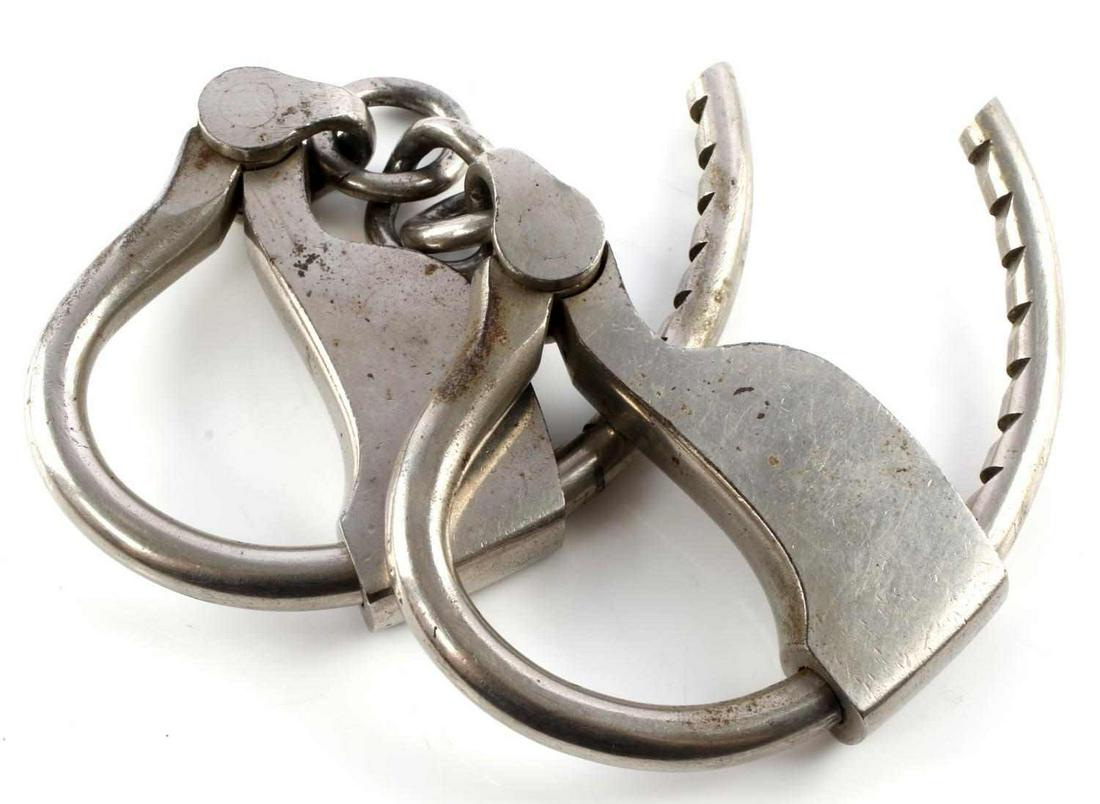 ANTIQUE TOWER HANDCUFFS W/O KEY: Steel vintage tower handcuffs, key not included. Good condition. Patent date marked with 1882 as the last. 8.75 inches long. Good condition.