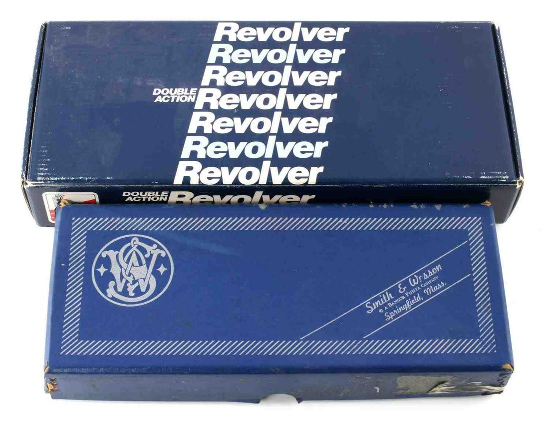 2 SMITH & WESSON EMPTY DISPLAY BOXES: 2 Smith & Wesson empty display boxes in good condition. One reads "Double Action Revolver" on top. Some adhesive on smaller box, tags on both boxes.