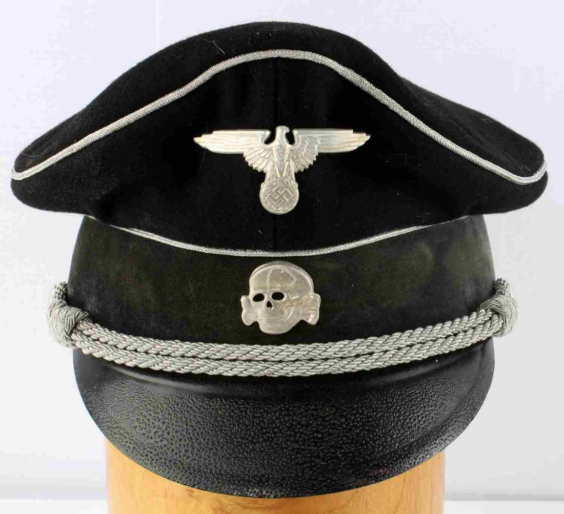 WWII THIRD REICH GERMAN SS OFFICER TOPENKOPF VISOR: German Third Reich SS Officer's Visor Cap, in black wool with velvet band. Eagle and skull insignia and bullion silver thread chinstrap. Interior marked with SS emblem. Size 59. Stitching fluoresces. 