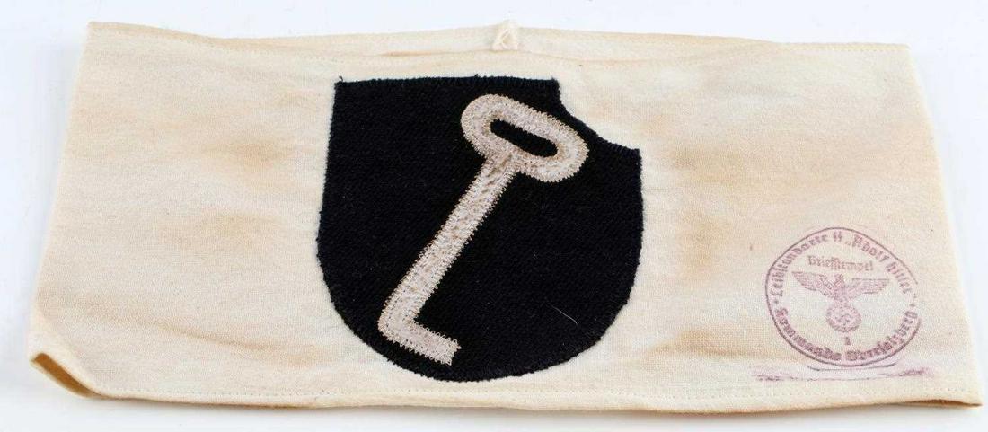 WWII GERMAN REICH LEIBSTANDARTE SSDIVISION ARMBAND: WWII German Reich Leibstandarte-SS "Adolf Hitler" armband in good condition. Interior reads "Hauptsitz Division Inspiziert 1943". Design on front fluoresces and/or reflects, although stitching does no